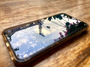 High angle view of cloudy sky seen through glass on table