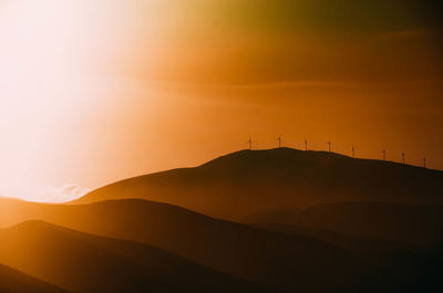 Scenic view of silhouette mountains against sky during dawn