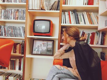 Midsection of woman reading book