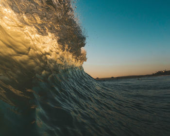 Scenic view of sea against clear sky during sunset