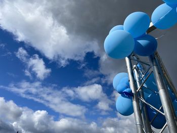 Low angle view of balloons against sky