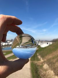 Close-up of hand holding blue sky