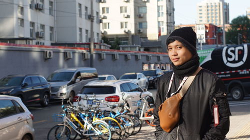 Portrait of young woman in city