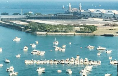 High angle view of sea by city against sky