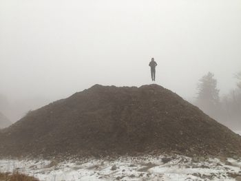 Silhouette of woman standing on landscape
