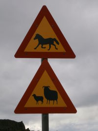 Low angle view of road sign against sky