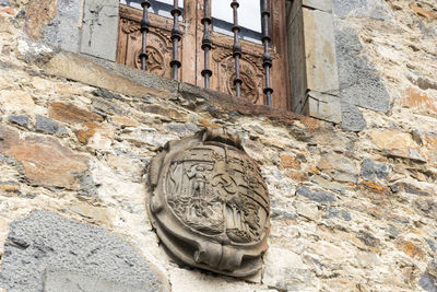 Low angle view of cat on old building