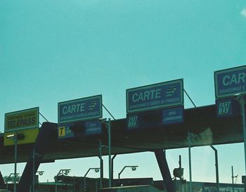Low angle view of road sign against clear sky