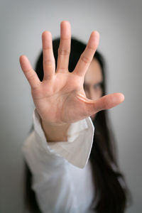 Close-up of human hand against gray background