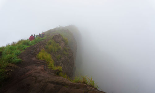 People hiking on mount batur during foggy weather