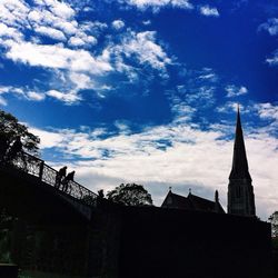Low angle view of building against cloudy sky
