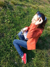 High angle view of woman sitting on field