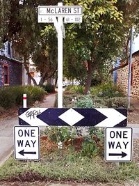 Road sign by trees