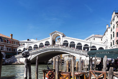 View of bridge over canal against blue sky