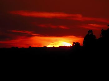 Silhouette landscape against sky during sunset