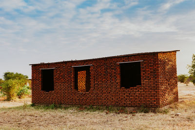 House on field against sky