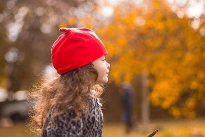 Close-up of girl with autumn leaves