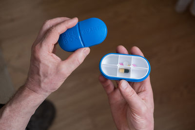 Cropped hand of person holding fidget spinner