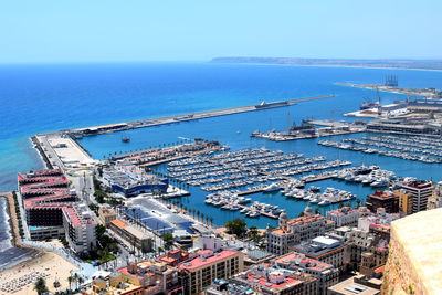 High angle view of city by sea against sky