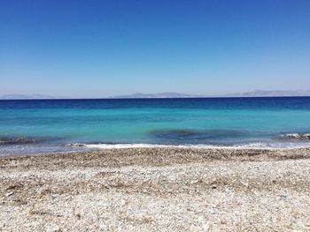 Scenic view of sea against clear blue sky