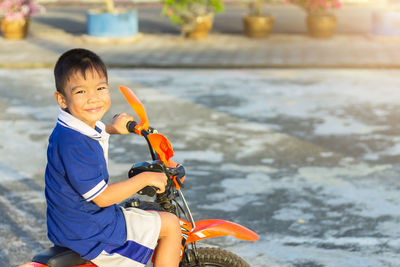 Smiling boy on motorcycle during winter