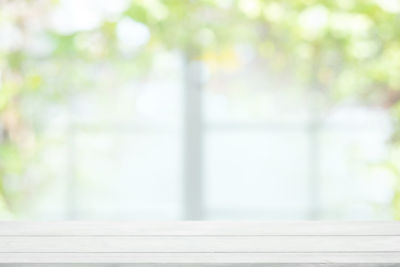 Close-up of window on table against trees