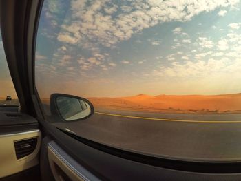 View of sunset through car window