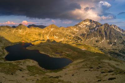 Scenic view of lake and mountains against sky