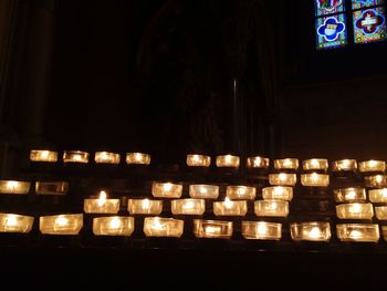 Illuminated tea light candles at night