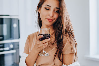 Portrait of beautiful woman drinking glass