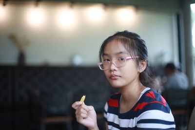 Portrait of boy holding eyeglasses