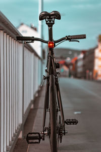 Close-up of bicycle on street against wall