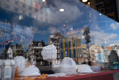 Close-up of man standing by window glass