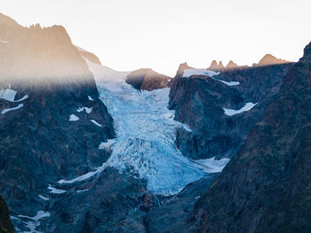 Scenic view of snow covered mountains against clear sky