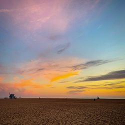 Scenic view of beach against sky during sunset