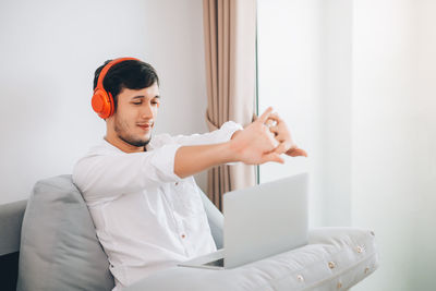 Young man using mobile phone at home