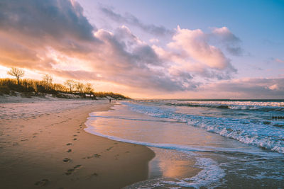 Scenic view of beach against sky during sunset