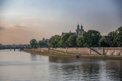 Tranquil vistula river with wawel castle in the distance
