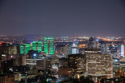 High angle view of illuminated city buildings against sky