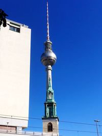 Low angle view of communications tower against sky