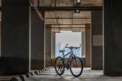 Bicycle parked on bridge against building