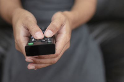 Midsection of man using mobile phone