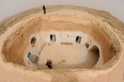 High angle view of men standing on sand