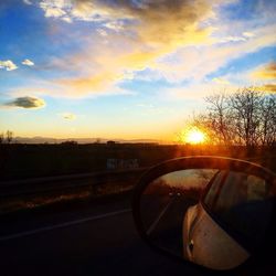 Cars on road at sunset