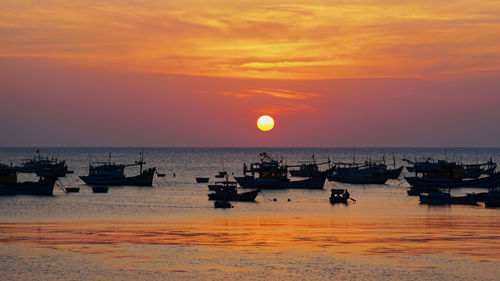 Scenic view of sea against orange sky