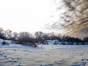 Snow covered landscape against sky