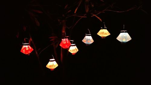 Close-up of illuminated lighting equipment hanging on wall