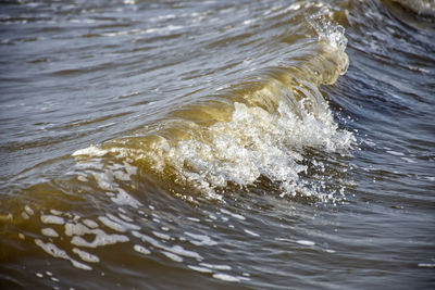 High angle view of waves splashing in sea