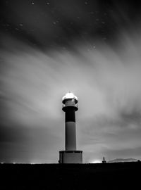 Low angle view of far del afangar lighthouse  against sky at night