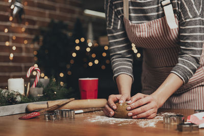 Midsection of woman preparing food on table at home